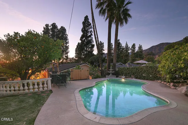 a view of a backyard with plants and a patio