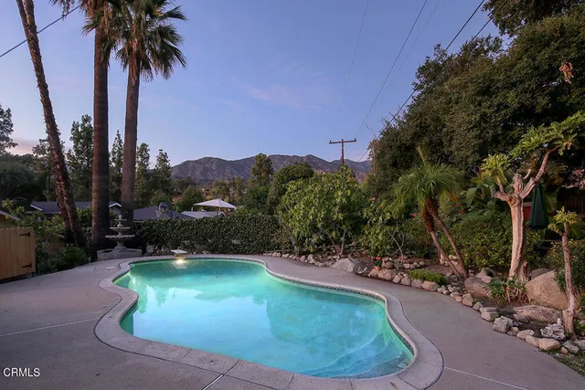a view of a patio with furniture and a garden