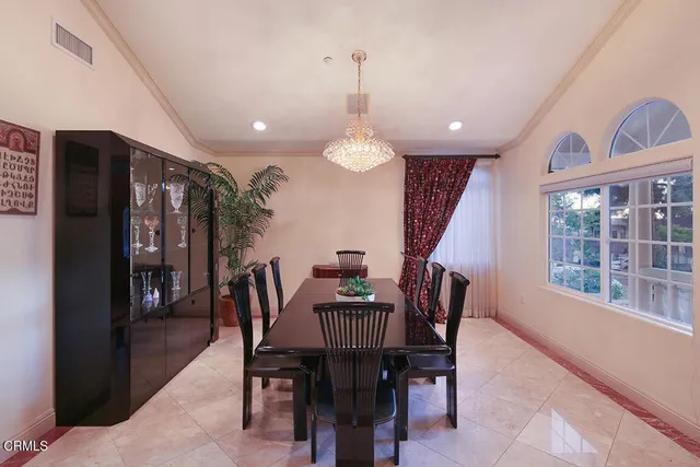 a view of a hallway with wooden floor and a chandelier