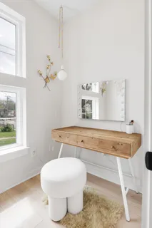 a kitchen with stainless steel appliances granite countertop a stove a sink a refrigerator a microwave a dining table and chairs with wooden floor