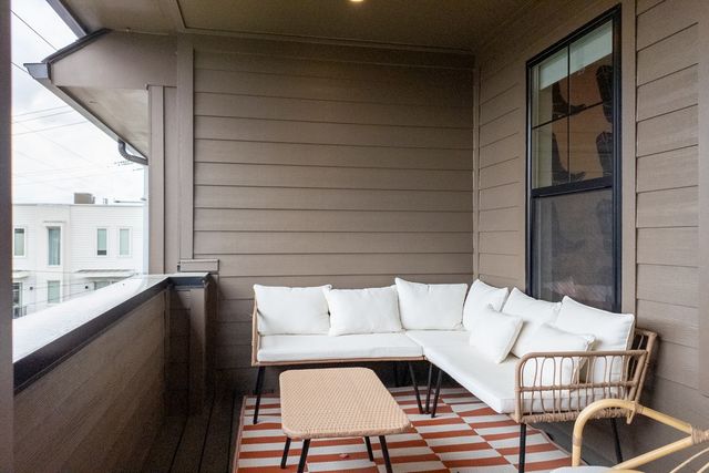 a kitchen with stainless steel appliances a stove a sink a microwave a dining table and chairs