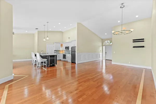a view of a kitchen with dining area wooden floor and appliances