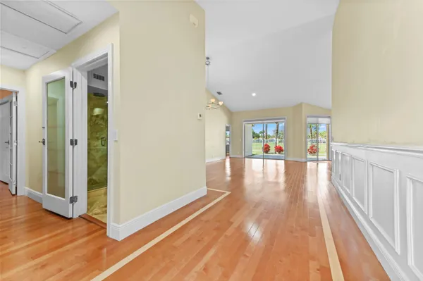 a view of a hallway view with wooden floor and windows