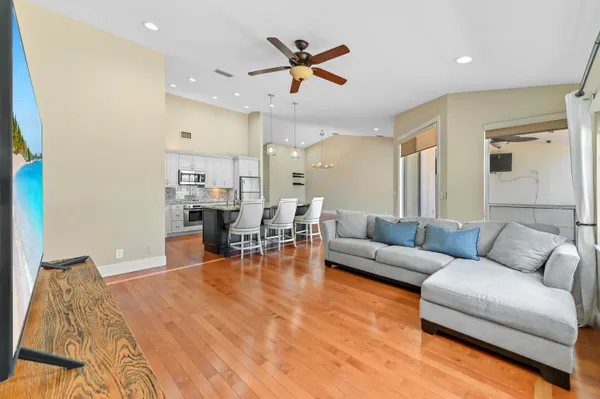 a living room with furniture and kitchen view