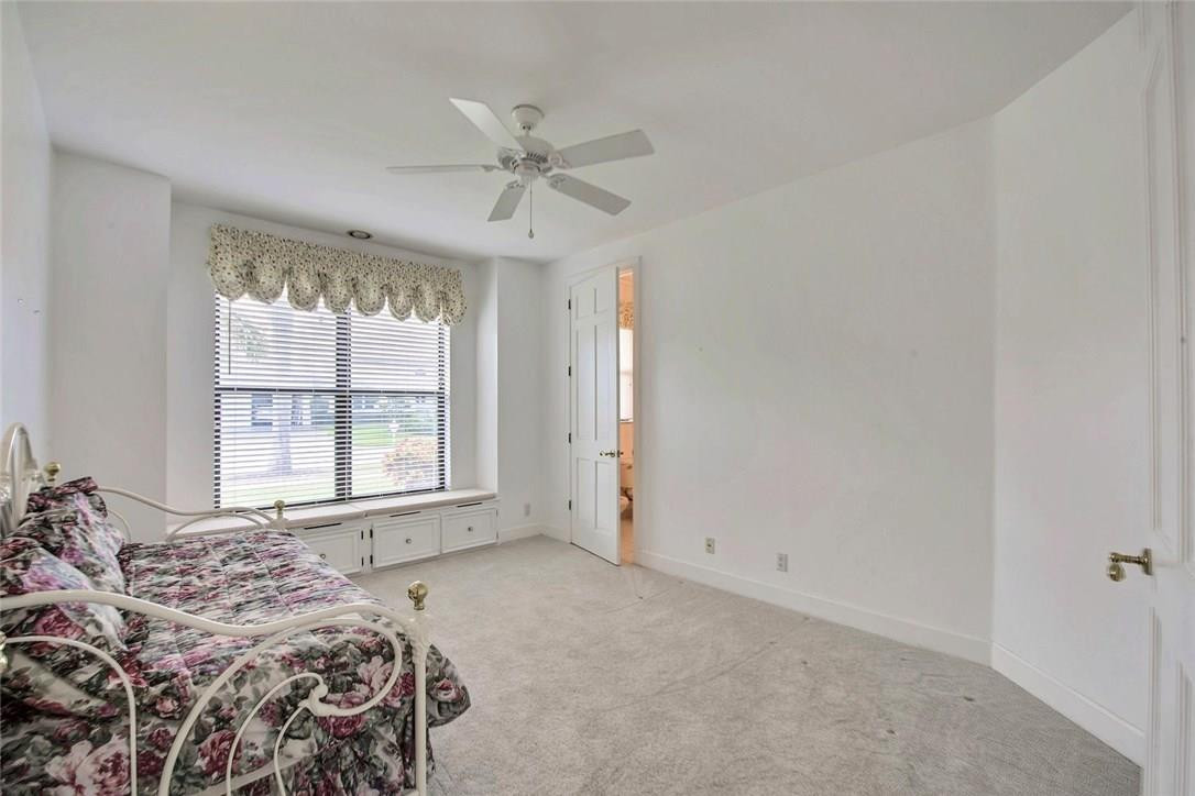 821 Northeast 77th Street Boca Raton, FL 33487 - Photo 26 of 31 a bedroom with a large bed and a window