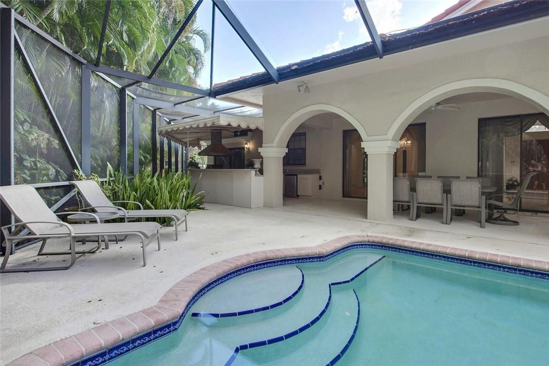 821 Northeast 77th Street Boca Raton, FL 33487 - Photo 8 of 31 a room with lots of potted plants and white walls
