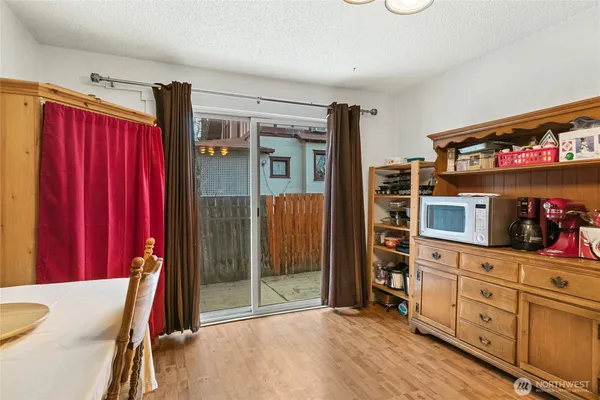 a view of a hallway with closet and cabinet