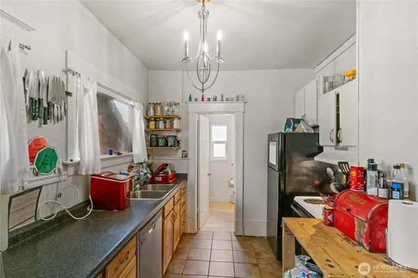 a kitchen with stainless steel appliances granite countertop a refrigerator a stove and a sink