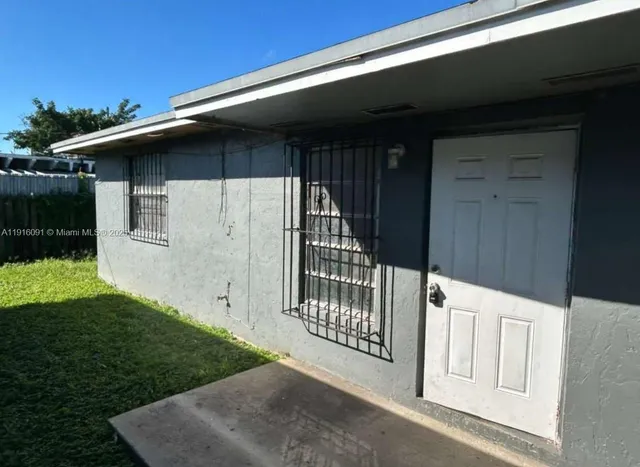 a side view of a house with a yard