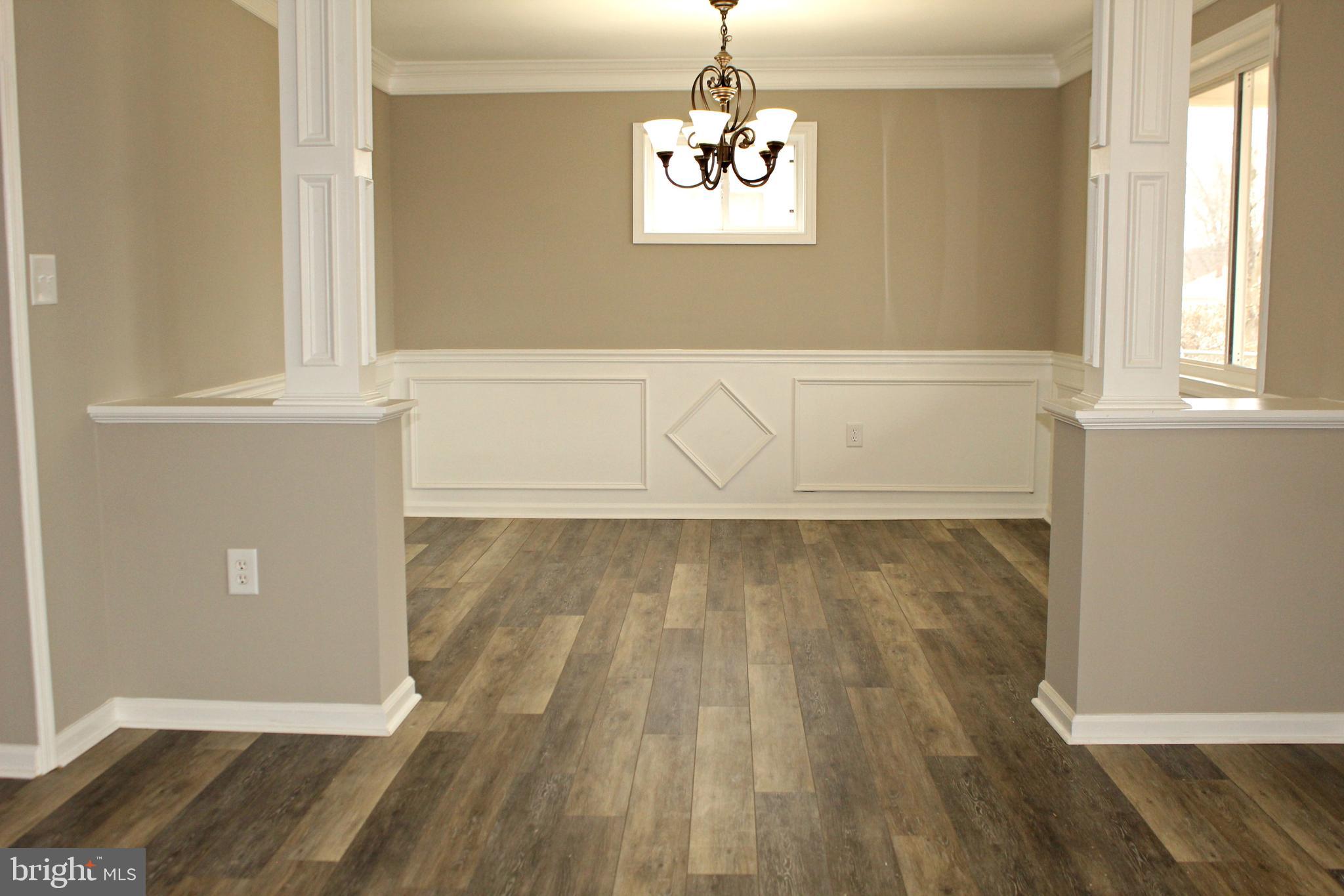 545 Compass Road East Baltimore, MD 21220 - Photo 2 of 30 wooden floor in an empty room with a window