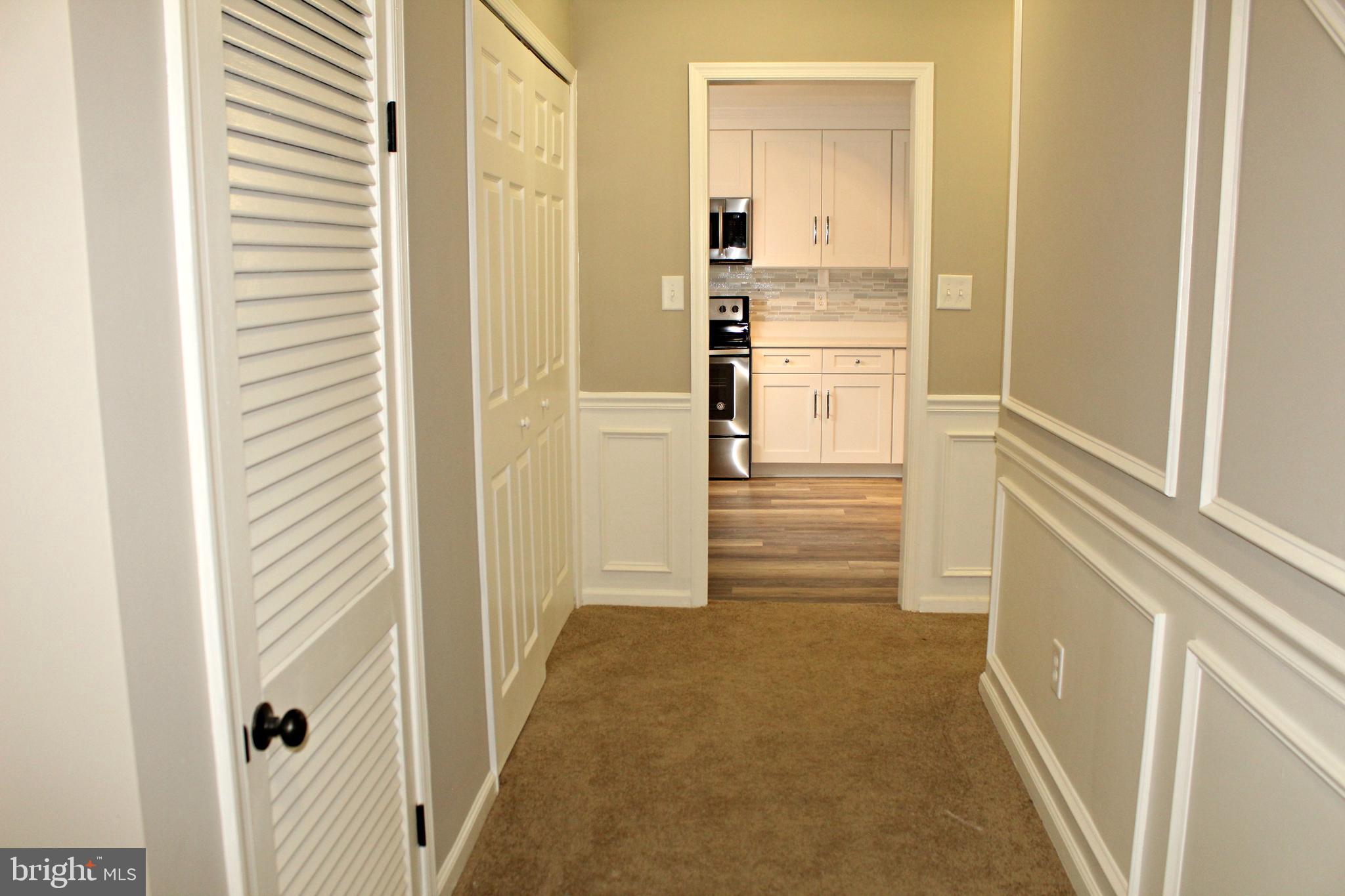 545 Compass Road East Baltimore, MD 21220 - Photo 12 of 30 a view of a hallway with wooden floor and closet