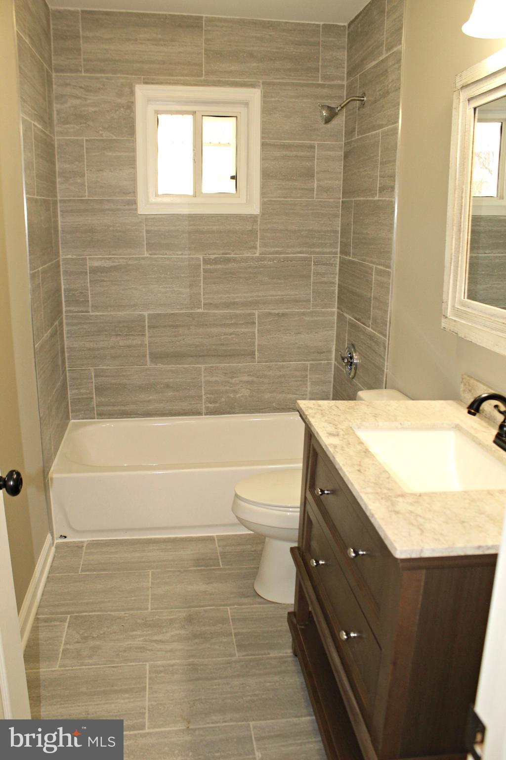545 Compass Road East Baltimore, MD 21220 - Photo 14 of 30 a bathroom with a granite countertop toilet a sink and bathtub