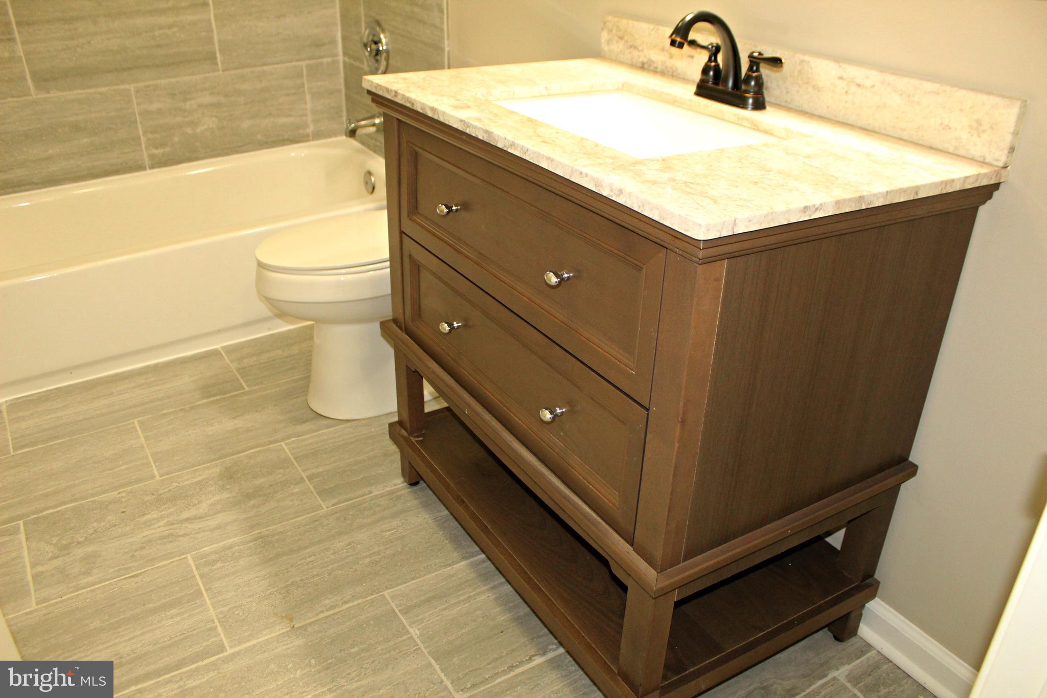 545 Compass Road East Baltimore, MD 21220 - Photo 17 of 30 a bathroom with a sink a toilet and bathtub