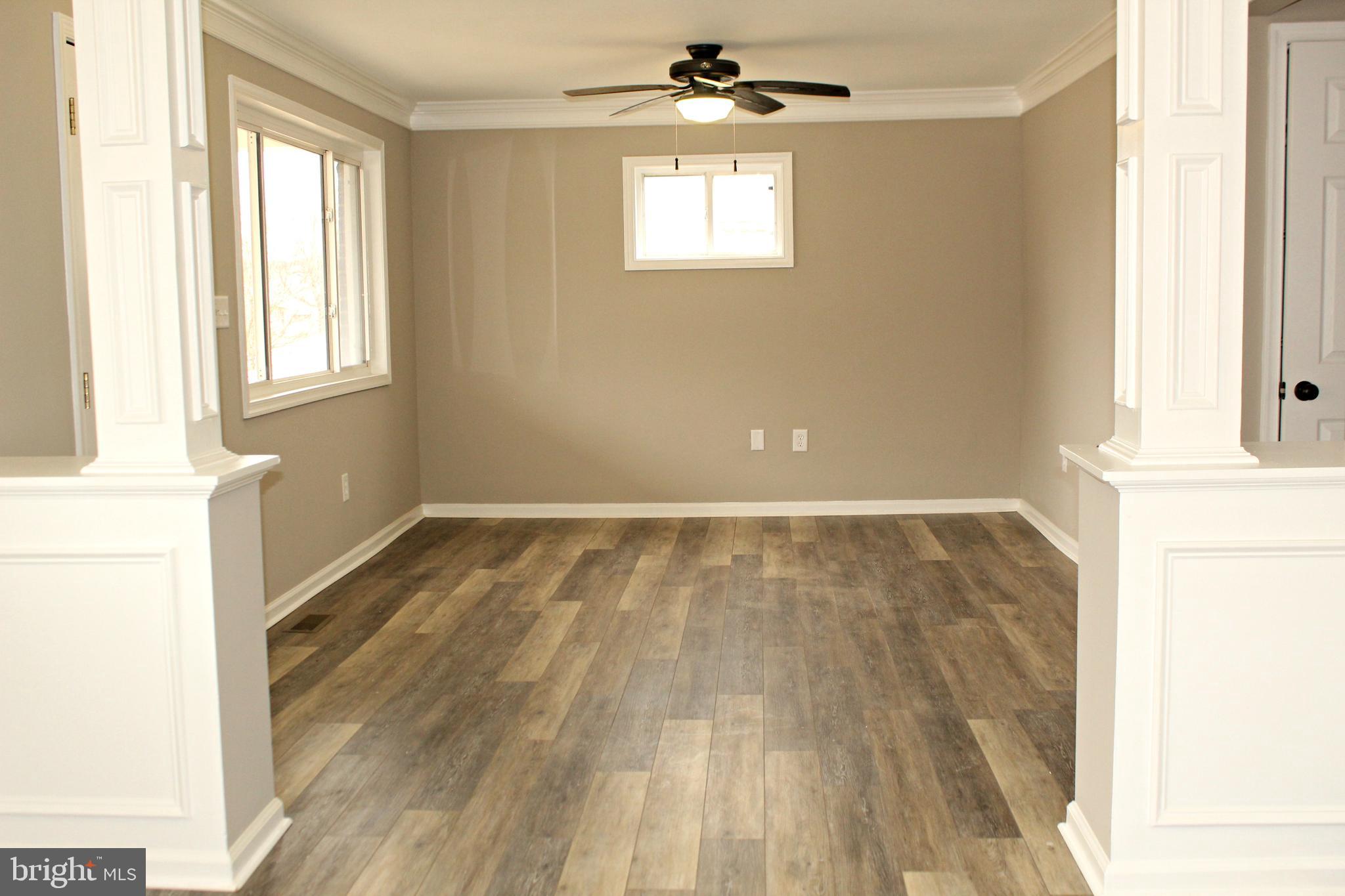 545 Compass Road East Baltimore, MD 21220 - Photo 3 of 30 a view of an empty room with wooden floor and a window