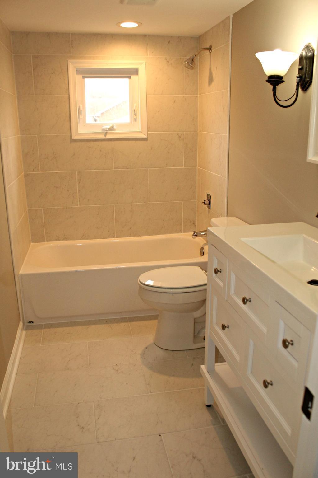 545 Compass Road East Baltimore, MD 21220 - Photo 23 of 30 a bathroom with a toilet a sink and bathtub