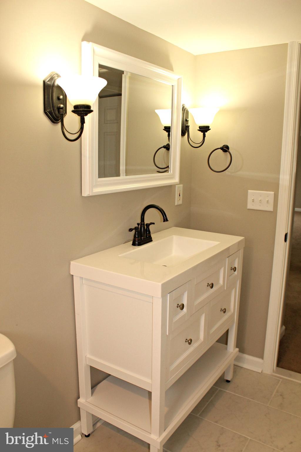 545 Compass Road East Baltimore, MD 21220 - Photo 25 of 30 a bathroom with a sink and mirror