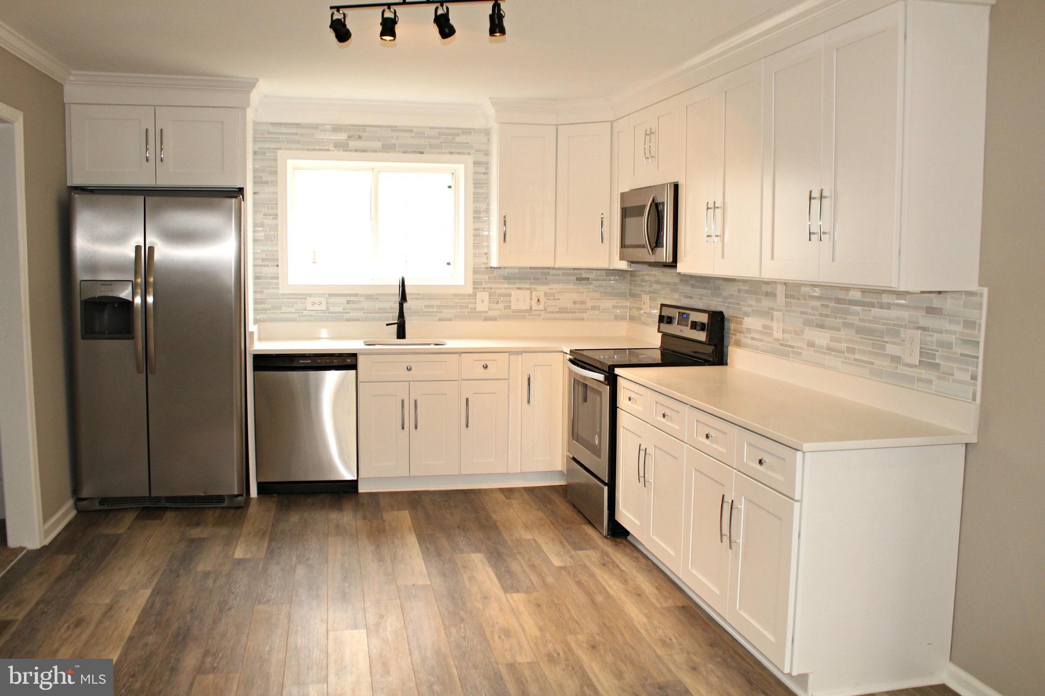 545 Compass Road East Baltimore, MD 21220 - Photo 4 of 30 a kitchen with stainless steel appliances granite countertop a sink a stove and refrigerator
