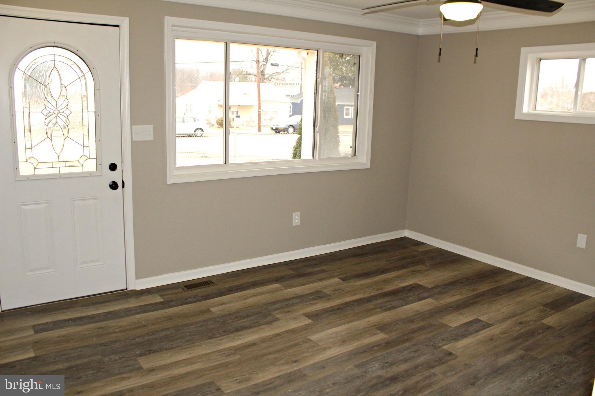 545 Compass Road East Baltimore, MD 21220 - Photo 10 of 30 a view of empty room with wooden floor and fan