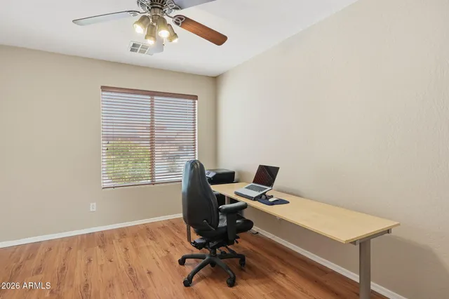 a view of workspace with wooden floor windows
