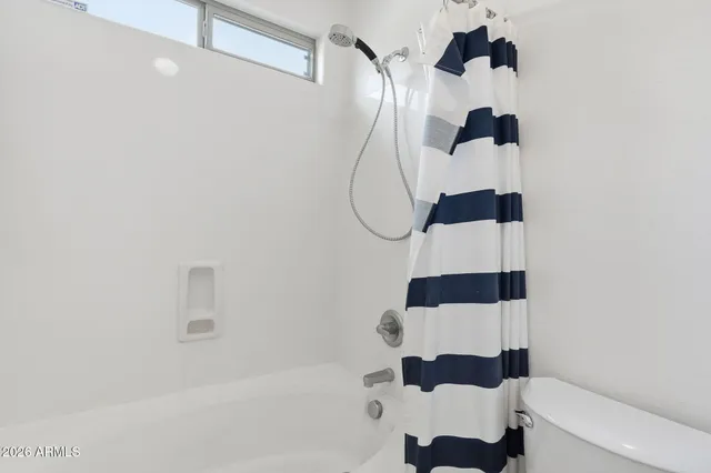 a bathroom with a shower and a window