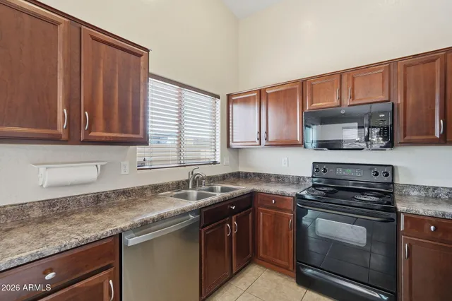 a kitchen with stainless steel appliances granite countertop a sink stove and microwave