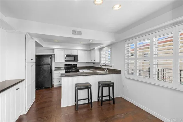 a kitchen with stainless steel appliances granite countertop a stove and a refrigerator