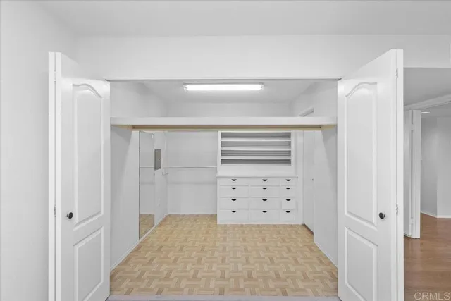 a view of walk in closet with cabinet