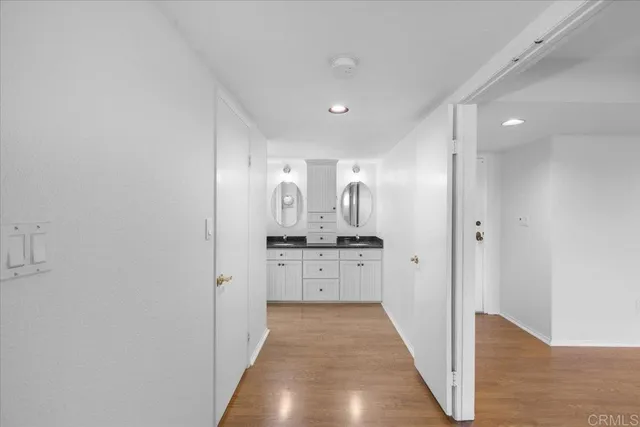 a bathroom with a granite countertop sink a large mirror and a bathtub