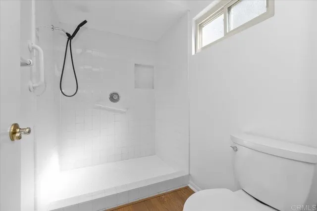 a bathroom with a toilet and a shower