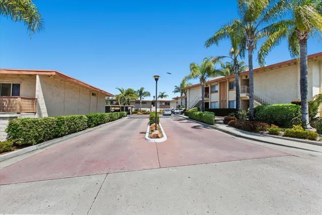 a view of a street with potted plants