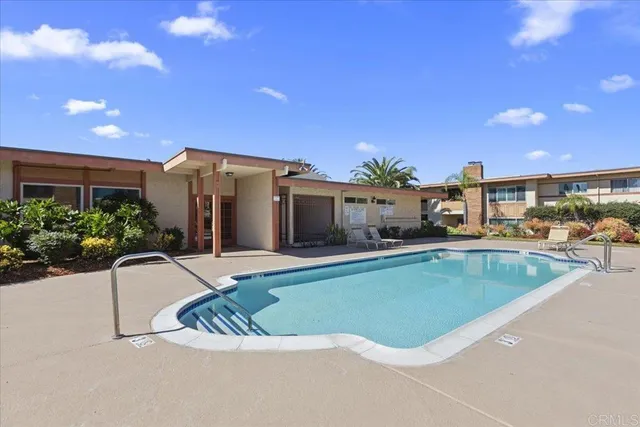 a view of a house with swimming pool and sitting area