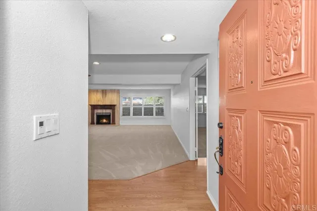 view of hall way with wooden floor and windows