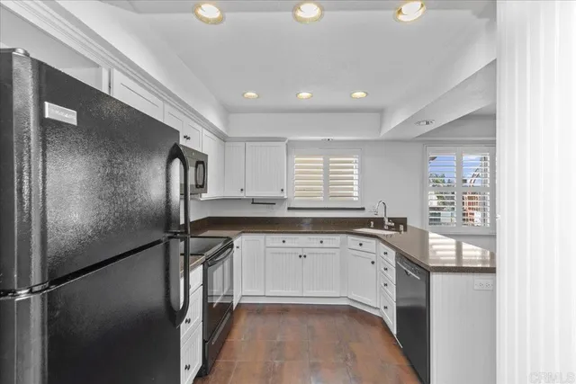 a kitchen with granite countertop a sink stainless steel appliances and cabinets