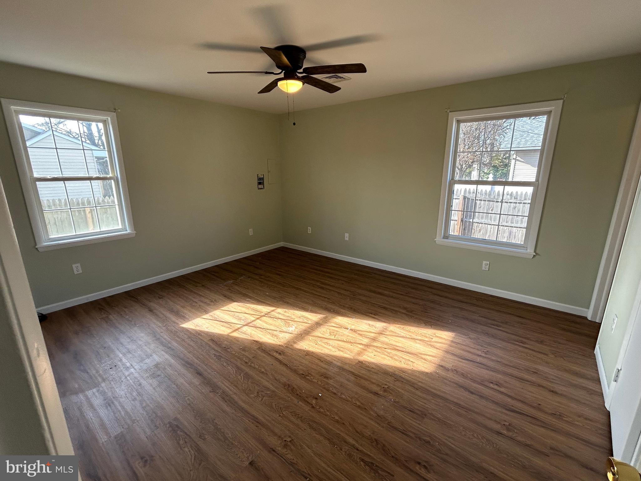 254 G Street Carneys Point, NJ 08069 - Photo 11 of 19 a view of an empty room with wooden floor and a window