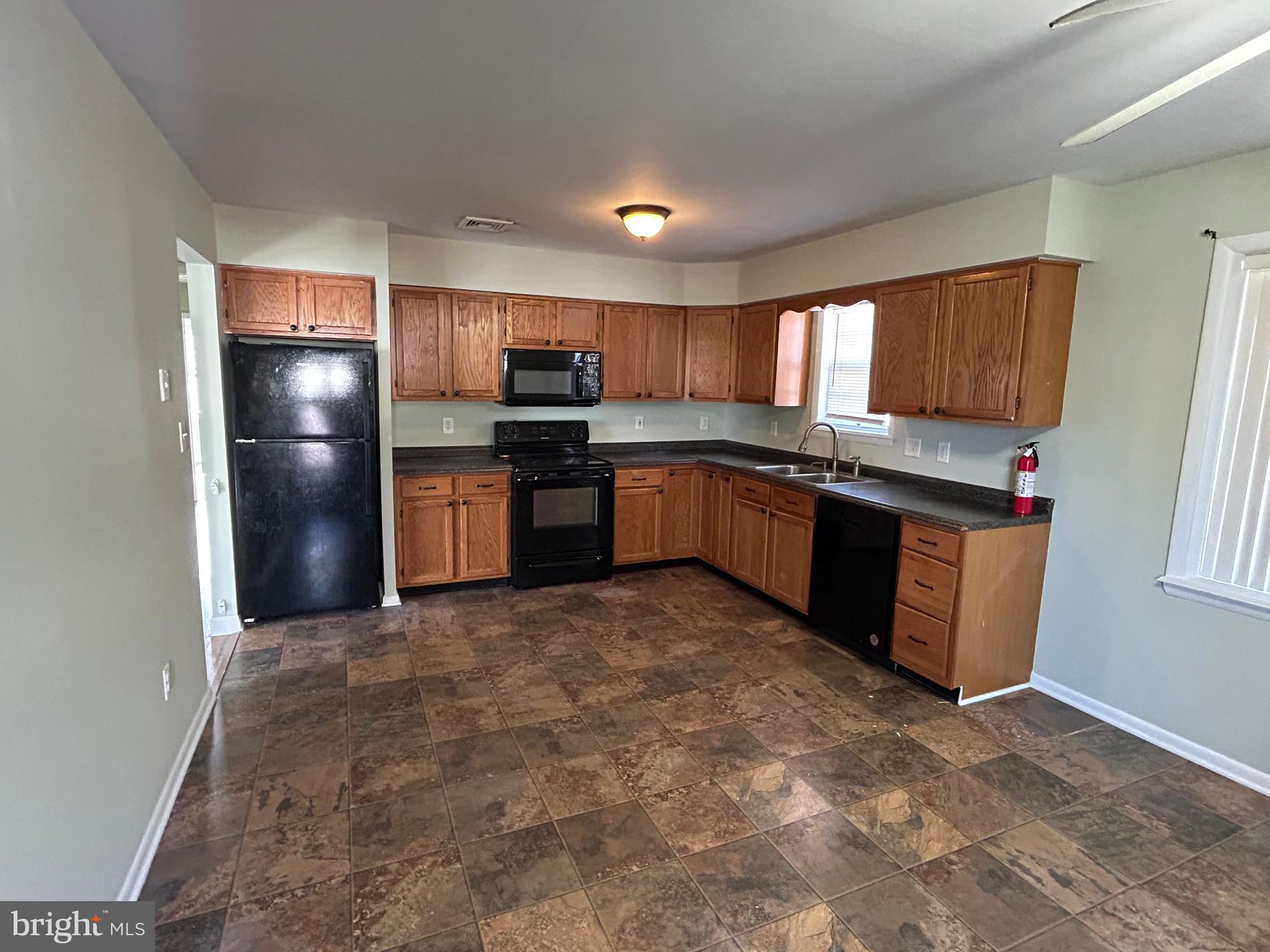 254 G Street Carneys Point, NJ 08069 - Photo 6 of 19 a kitchen with stainless steel appliances granite countertop a refrigerator and a sink