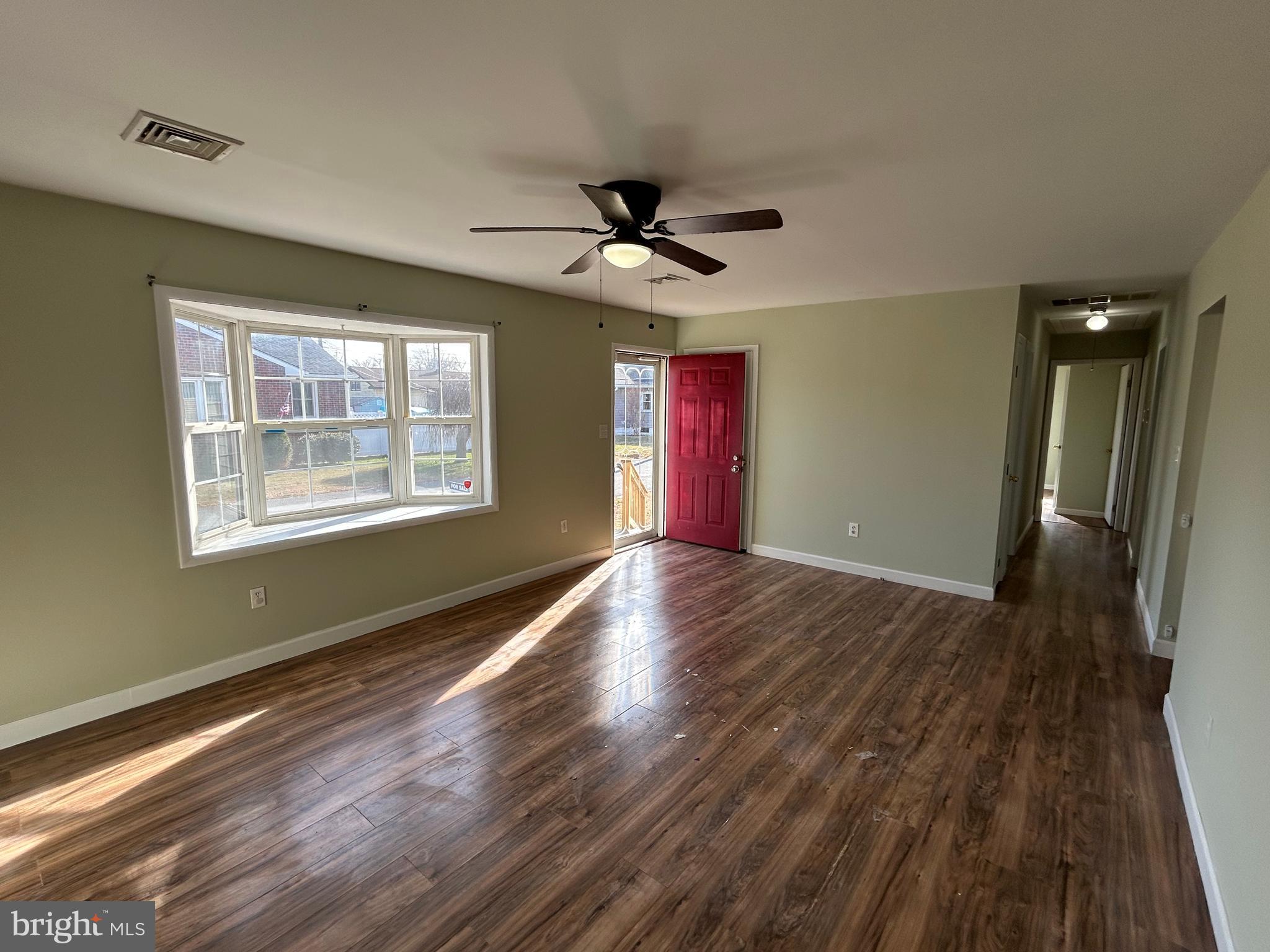 254 G Street Carneys Point, NJ 08069 - Photo 8 of 19 a view of an empty room with wooden floor and a window