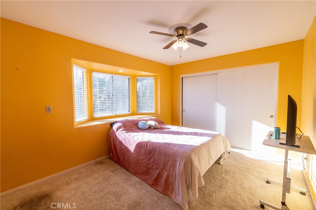 1277 Belridge Street, Unit 1A Oceano, CA 93445 - Photo 14 of 24 a bedroom with a bed and a flat screen tv