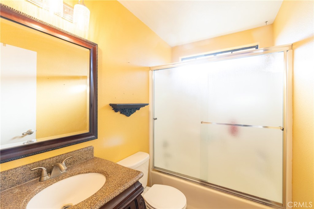 1277 Belridge Street, Unit 1A Oceano, CA 93445 - Photo 15 of 24 a bathroom with a granite countertop sink toilet and shower