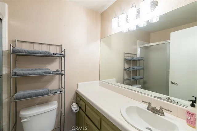 a bathroom with a sink a toilet and vanity