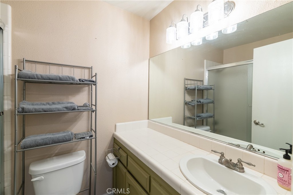 1277 Belridge Street, Unit 1A Oceano, CA 93445 - Photo 18 of 24 a bathroom with a sink a toilet and vanity