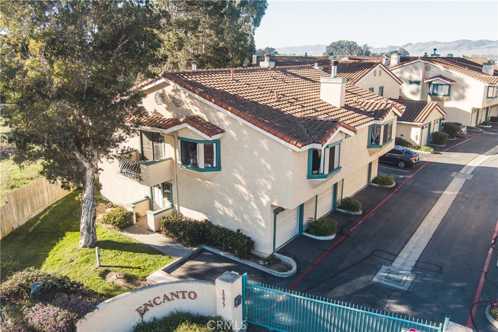 1277 Belridge Street, Unit 1A Oceano, CA 93445 - Photo 22 of 24 a front view of a house with a yard