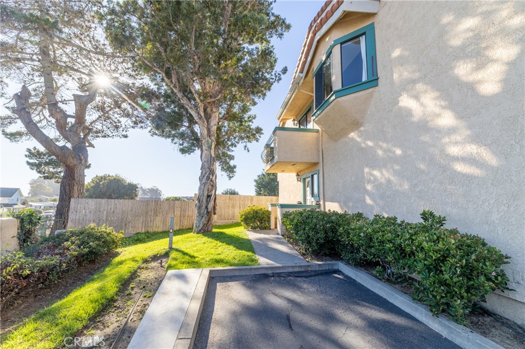 1277 Belridge Street, Unit 1A Oceano, CA 93445 - Photo 4 of 24 a view of a house with a big yard plants and large trees