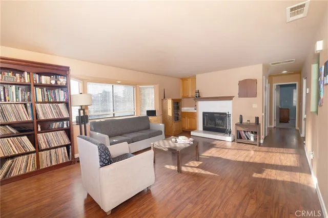 a living room with fireplace furniture and a wooden floor