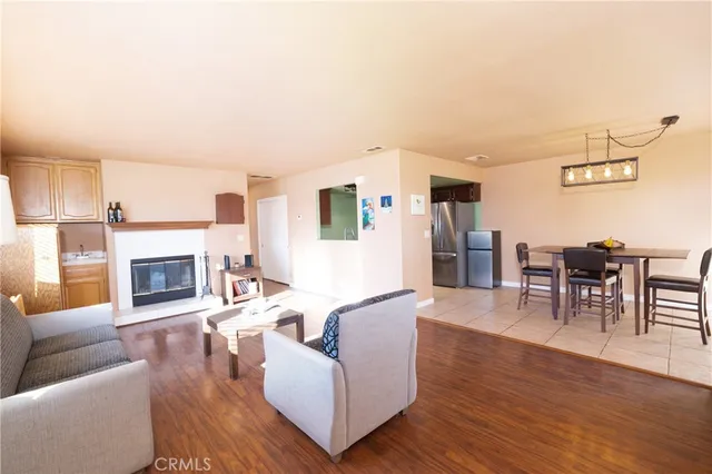 a living room with furniture a fireplace and wooden floor