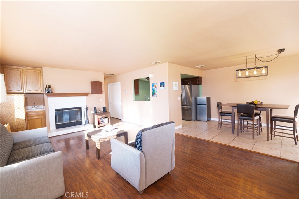 1277 Belridge Street, Unit 1A Oceano, CA 93445 - Photo 10 of 24 a living room with furniture a fireplace and wooden floor
