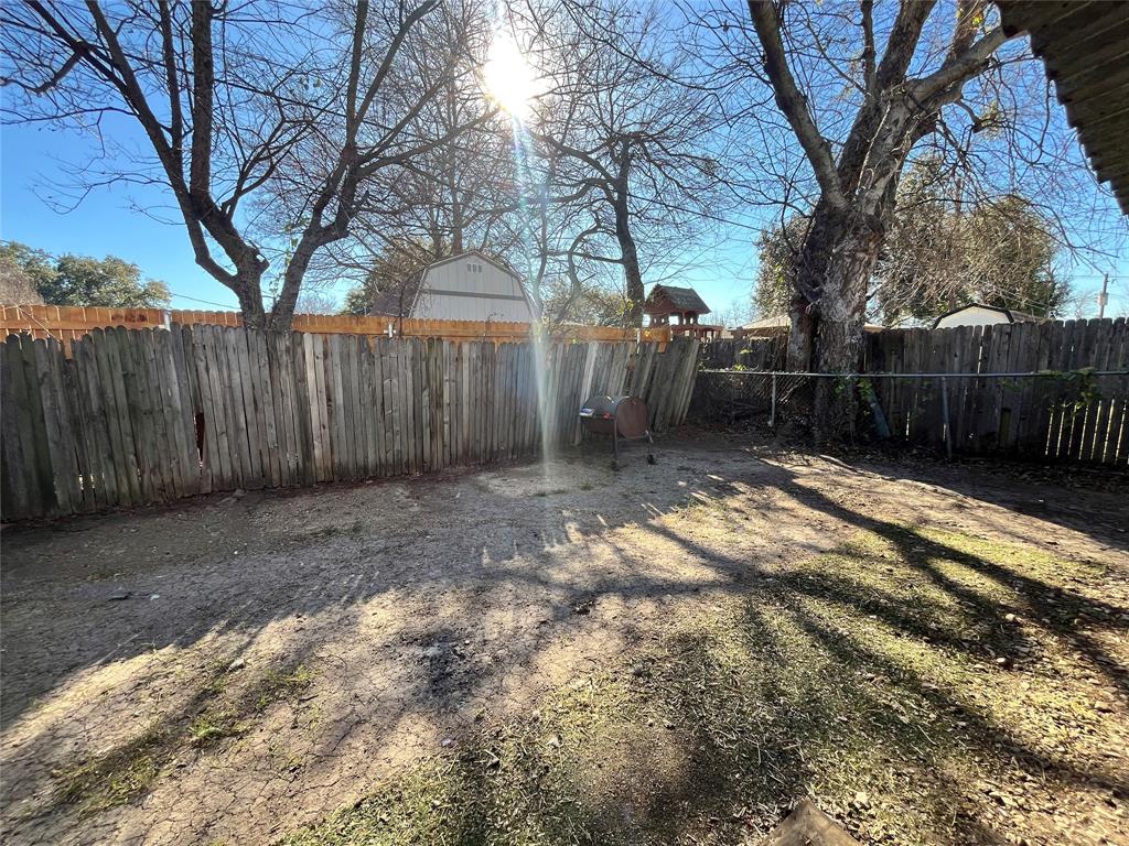 2427 January Lane Grand Prairie, TX 75050 - Photo 14 of 14 a backyard of a house with lots of green space