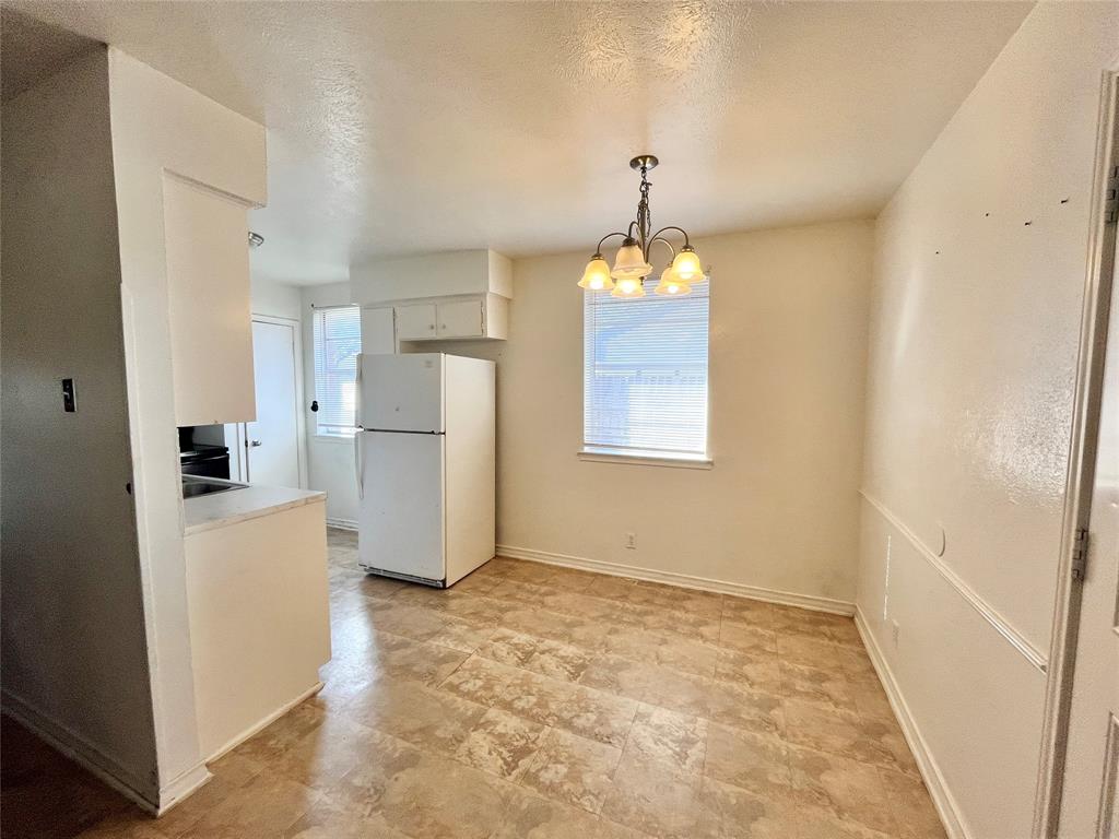 2427 January Lane Grand Prairie, TX 75050 - Photo 3 of 14 a view of a kitchen with a refrigerator a stove top oven and a refrigerator