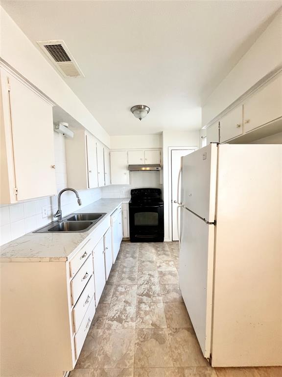 2427 January Lane Grand Prairie, TX 75050 - Photo 4 of 14 a large kitchen with a refrigerator a sink and dishwasher
