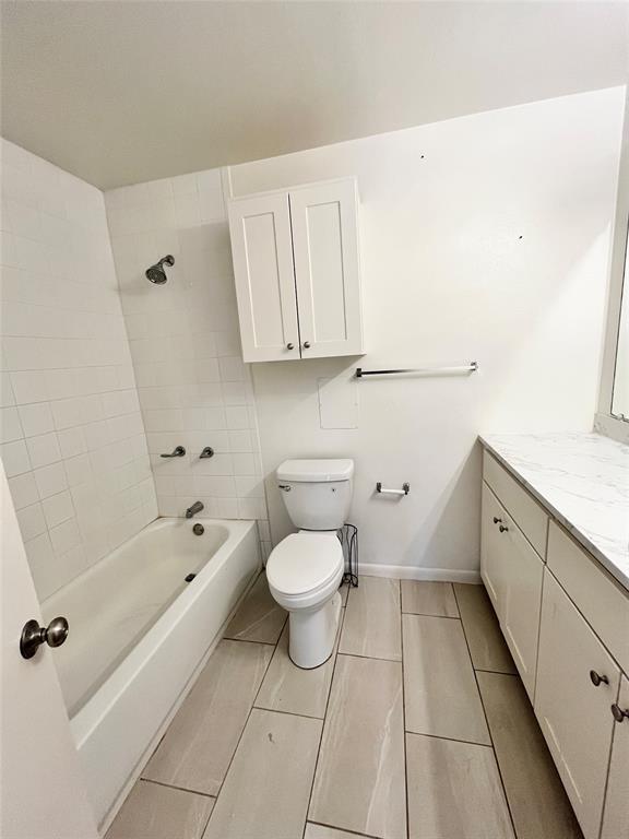2427 January Lane Grand Prairie, TX 75050 - Photo 9 of 14 a bathroom with a bathtub sink and toilet