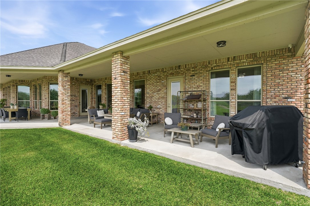 8710 KIng Ranch Drive Corpus Christi, TX 78414 - Photo 25 of 38 a view of a patio with table and chairs and potted plants